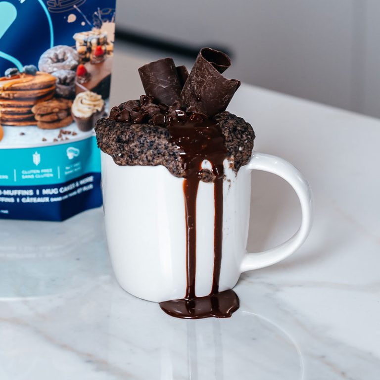 Chocolate mug cake in a white mug with chocolate topping